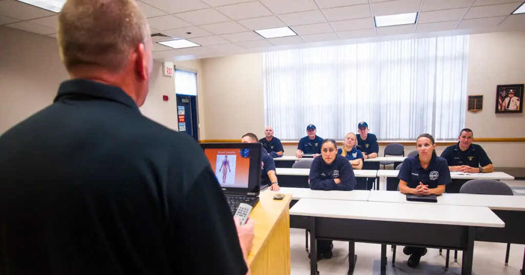 EVOC instructor leading a classroom session for EMTs, teaching emergency vehicle operations and preparing students for operator-level certification.