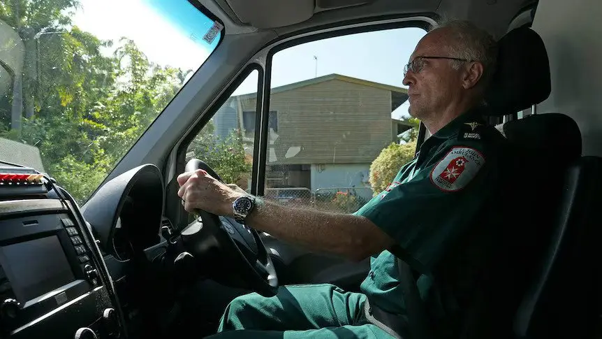 Emergency medical technician driving an ambulance during EVOC training, emphasizing safe following distance in emergency response situations