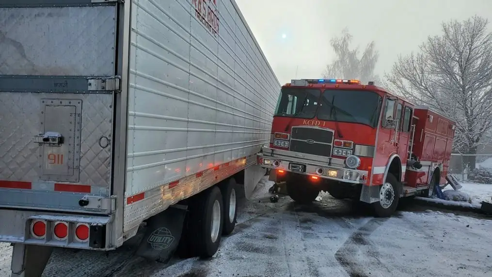Fire truck collided with a semi-trailer on icy road, highlighting the importance of emergency vehicle operator training versus commercial driver licensing