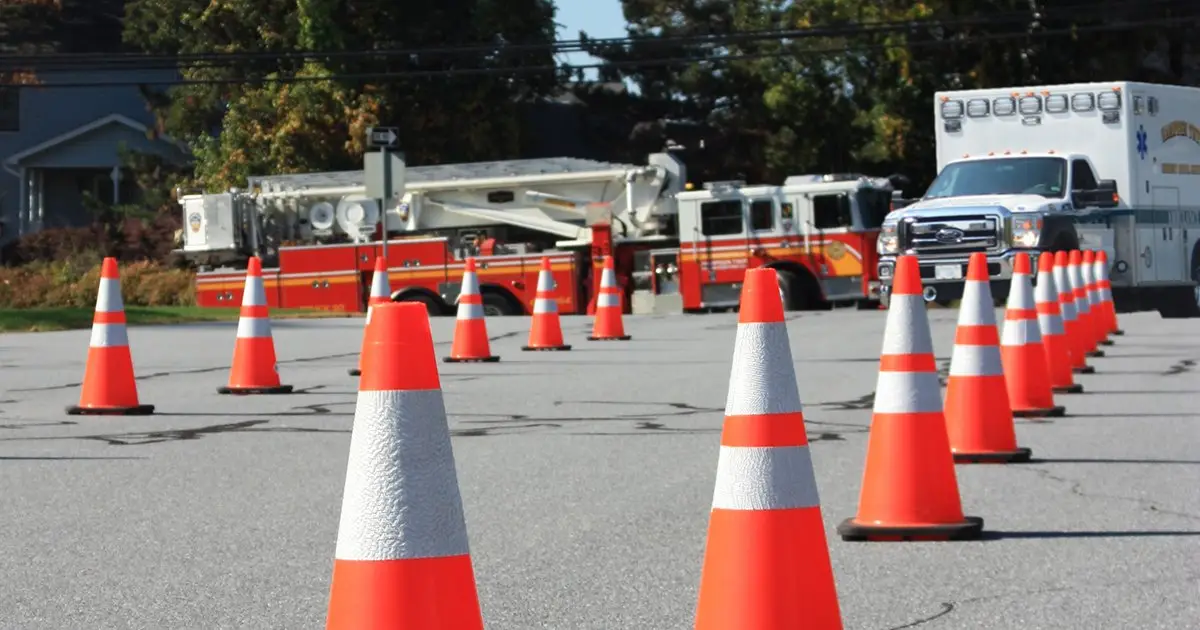 EVOC driving course with fire trucks, ambulance, and traffic cones used in emergency vehicle operator training