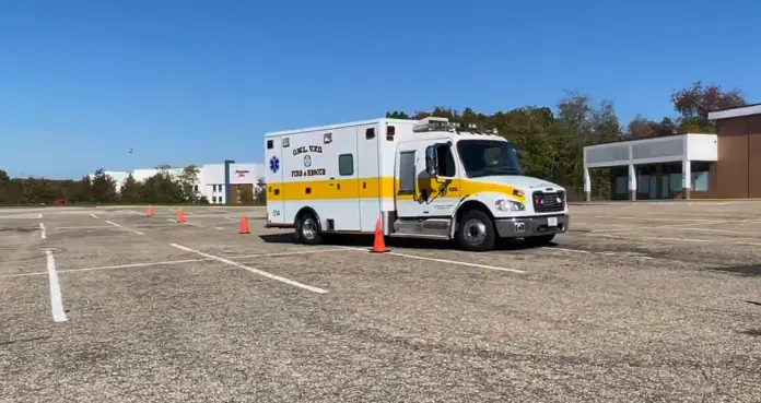 Ambulance driver practicing EVOC cone course during emergency vehicle operator training in Florida